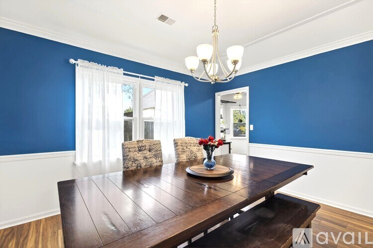 A dining room with a wooden table and chairs.