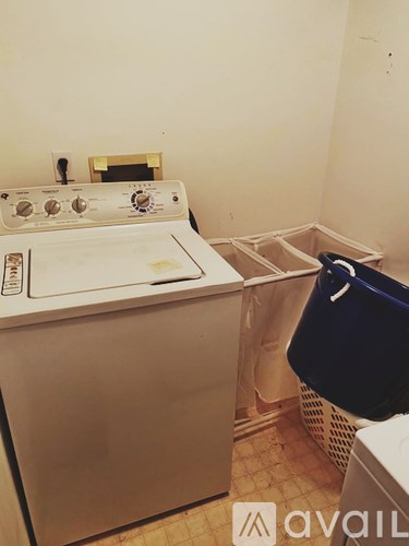 A white washing machine in a laundry room.