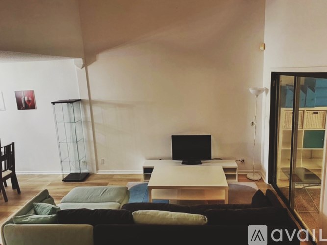 A living room with a couch, a television, and a chair.