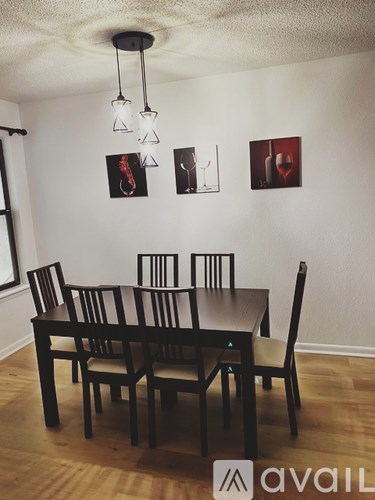 A dining room with a table and chairs.