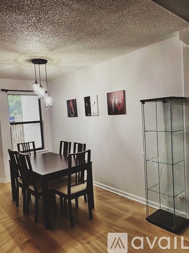 A dining room with a table and chairs.