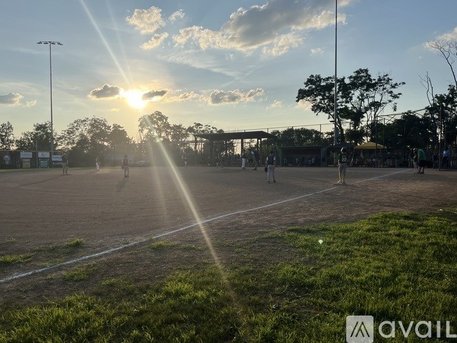A sunny day at the park with people walking around.