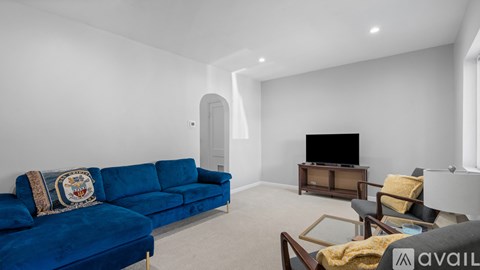 A living room with a blue couch and a television.