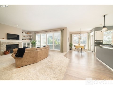 A living room with a beige couch and a fireplace.
