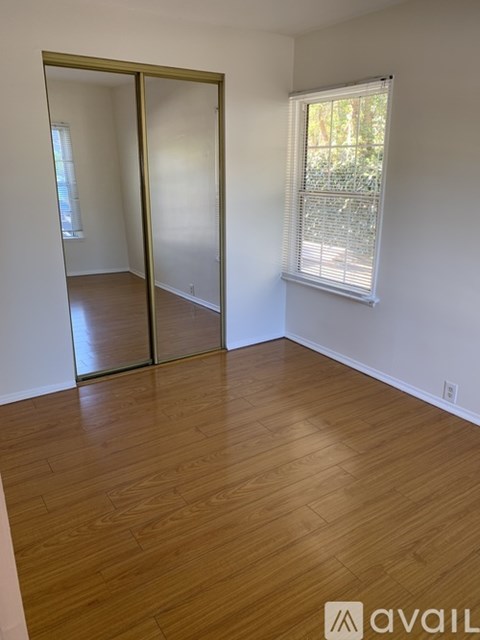 A room with wooden floors and a sliding glass door.