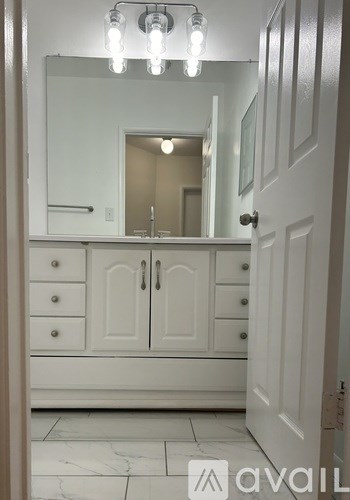 A room with a sliding door and wooden flooring.