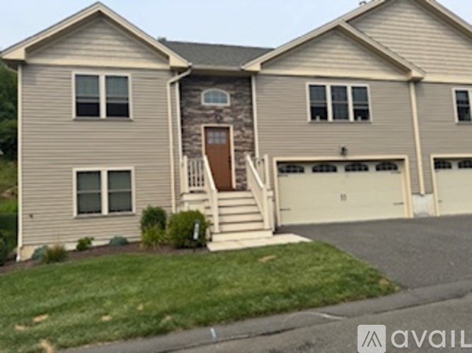 A two-story house with a garage on the right side.