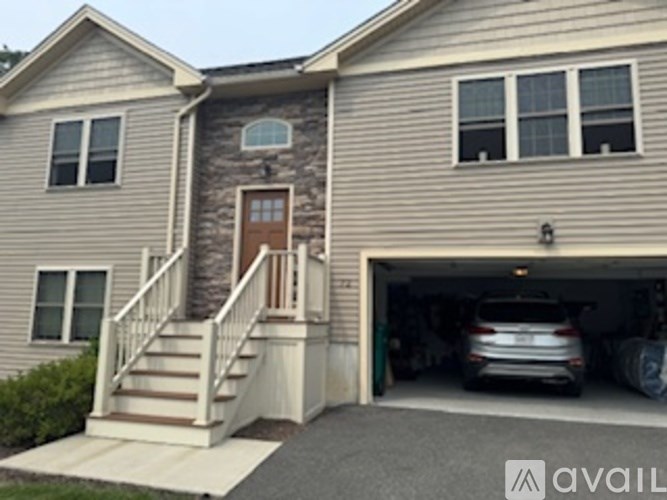 A house with a garage and a car inside.