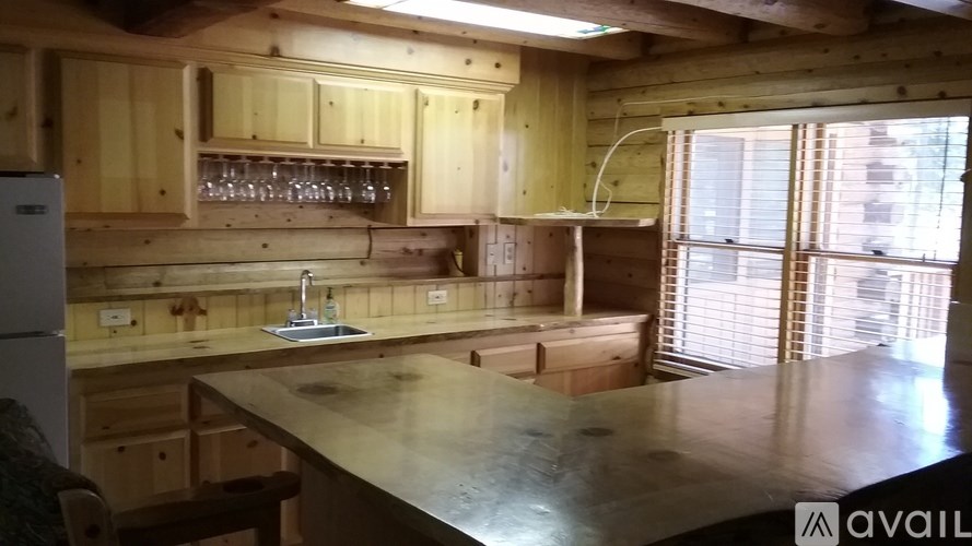 A kitchen with wooden cabinets and a large island.