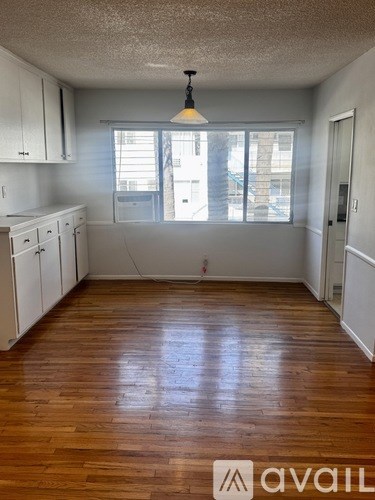 A room with wooden floors and white walls.