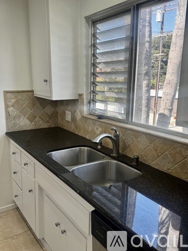 A kitchen with a sink and a window.