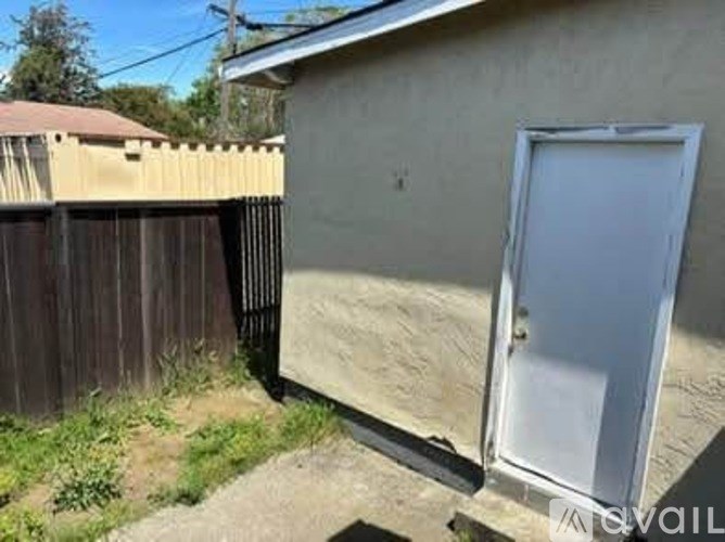 A white door is on the right side of a house.