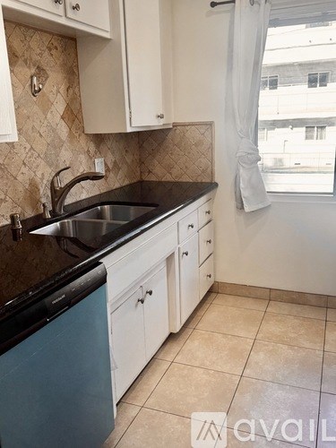A kitchen with a sink and cabinets.
