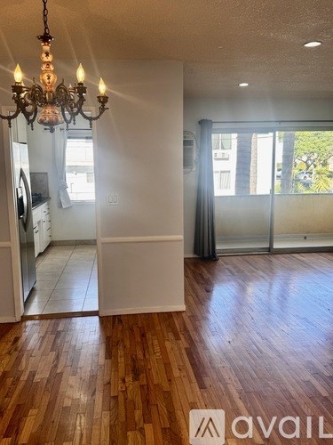 A room with wooden floors and a chandelier.