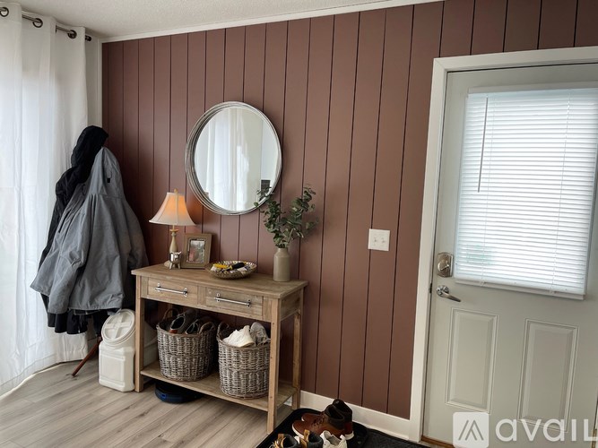 A room with a brown wall and a white door.