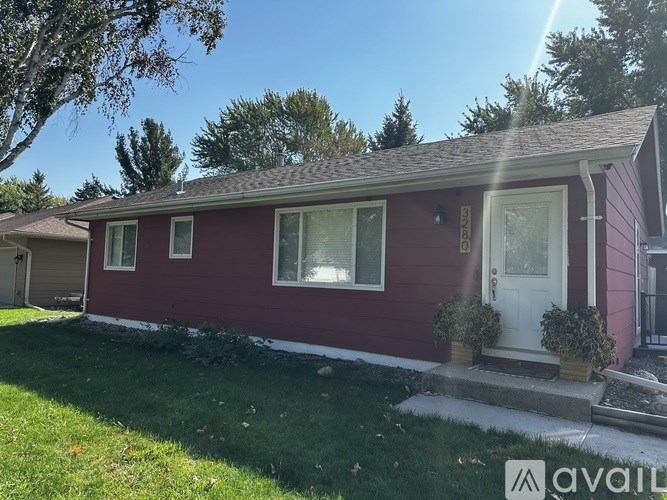 A red house with a white door and a small porch.