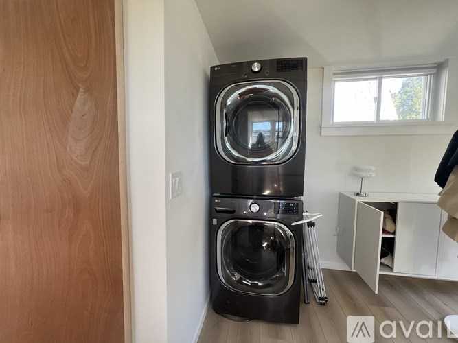 A large front loading washing machine in a laundry room.