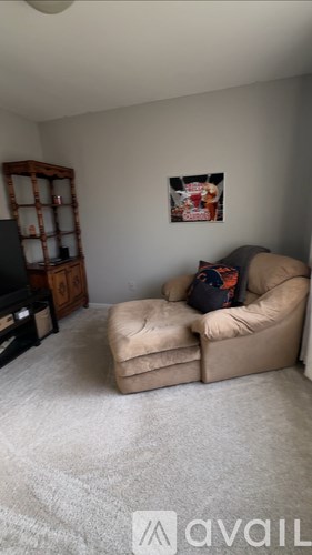 A living room with a couch and a chair.