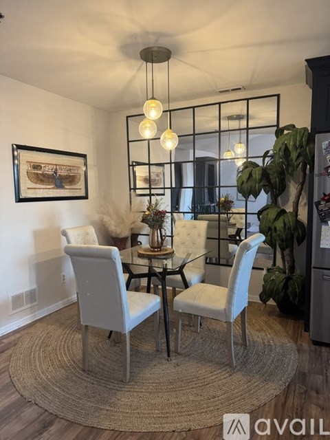A dining room with a glass table and chairs.