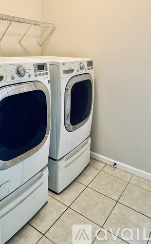 Two front loading washing machines in a laundry room.