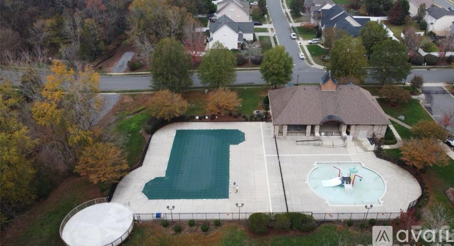 An aerial view of a house with a pool and a hot tub.