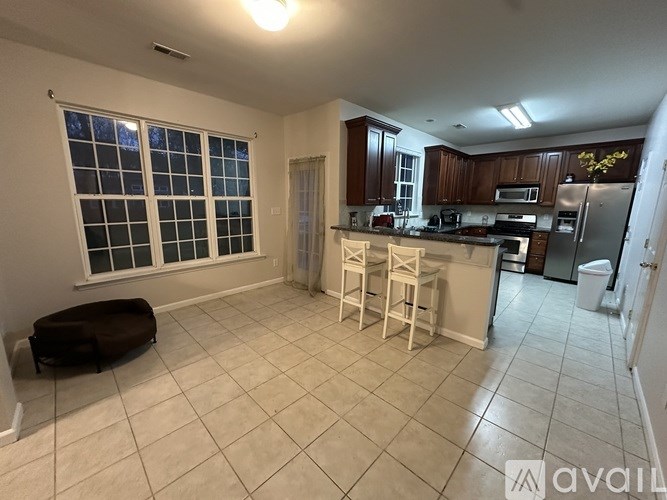 A kitchen with white cabinets and a large island.