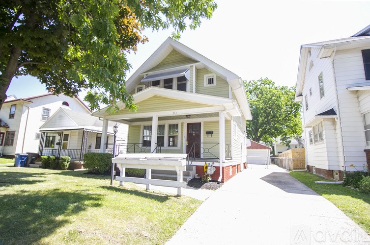 A house with a white fence in front of it.