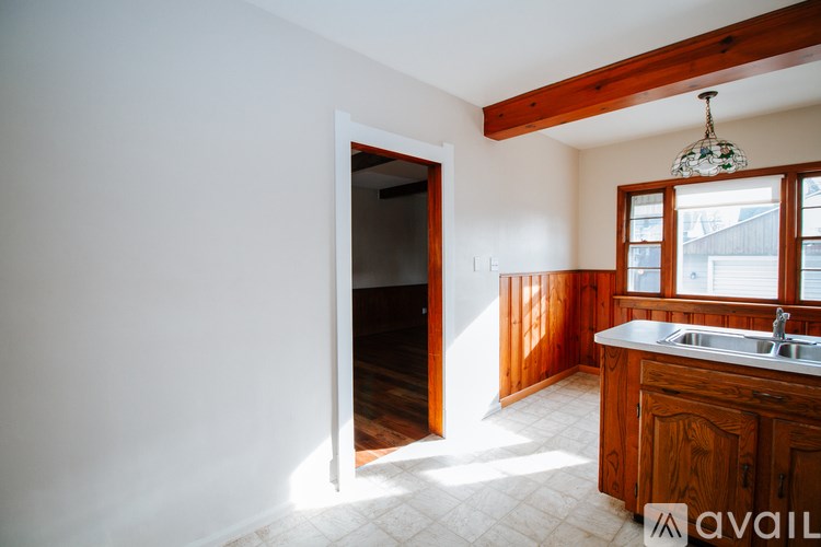 A kitchen with wooden cabinets and a white sink.