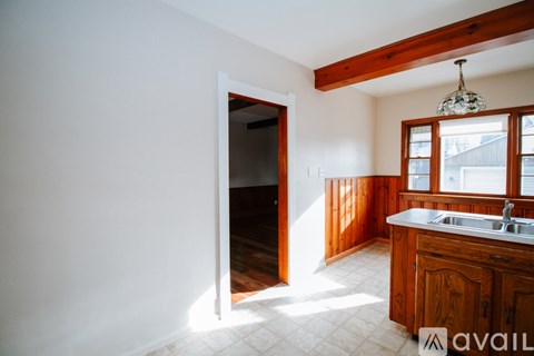 A kitchen with wooden cabinets and a white sink.
