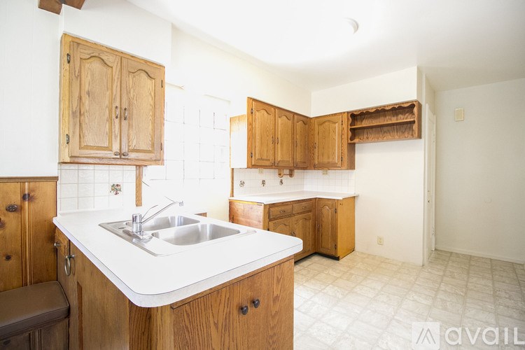 A kitchen with wooden cabinets and a white countertop.