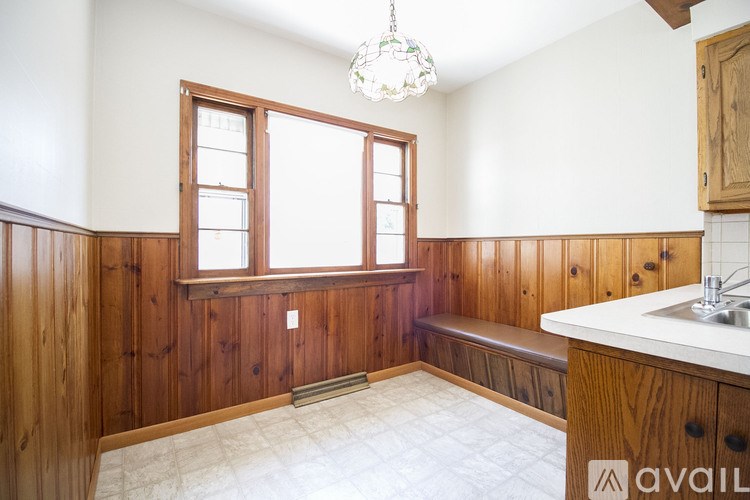 A room with wooden walls and a window.