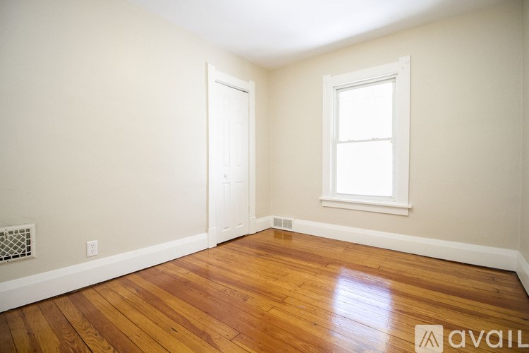 A room with wooden floors and a window.