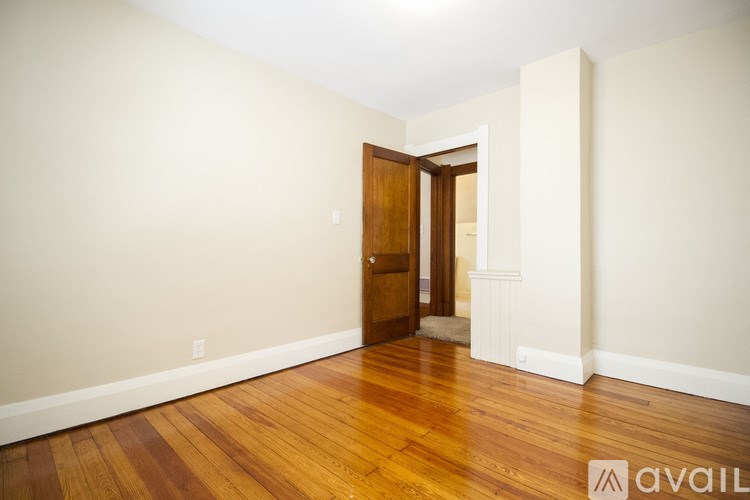 A room with wooden floors and a door.
