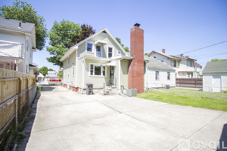 A house with a red brick chimney is for sale.
