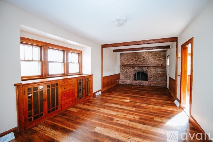A room with wooden floors and a fireplace.