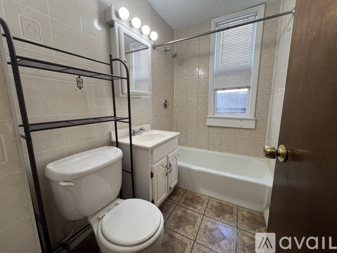 A bathroom with a toilet, sink, and bathtub.