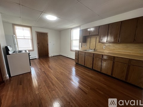 A kitchen with wooden floors and cabinets is available for rent.
