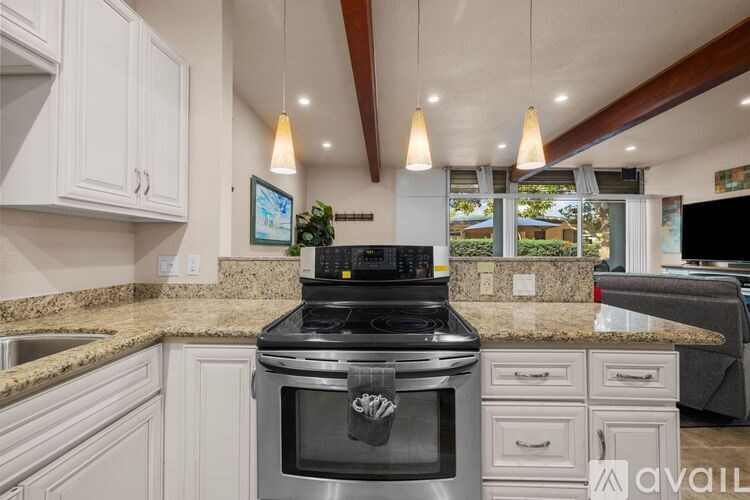 A modern kitchen with a black stove top oven.