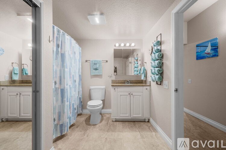 A bathroom with a toilet, sink, and shower.