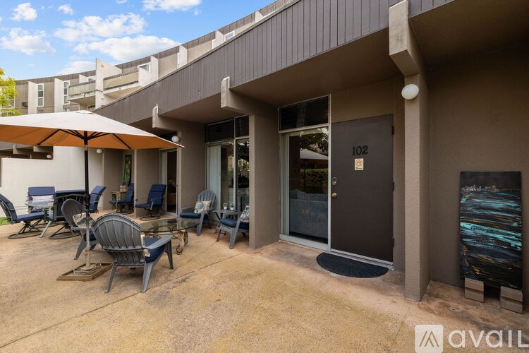 A patio area with chairs and an umbrella is available for use.
