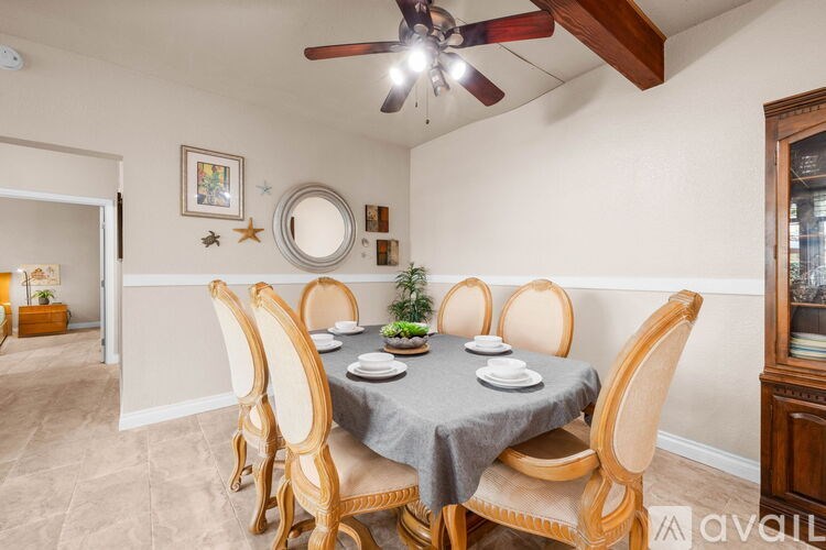 A dining room with a table set for six.