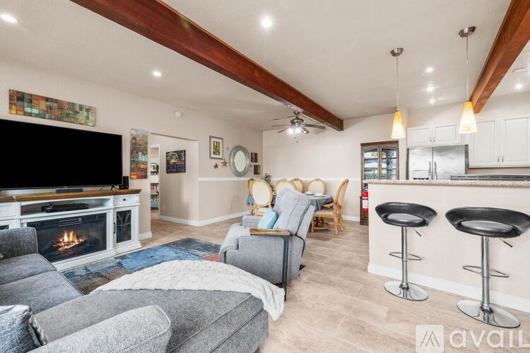 A living room with a fireplace and a television.