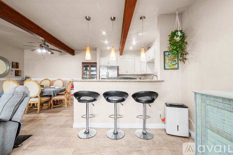 A kitchen with a bar area and a dining table.