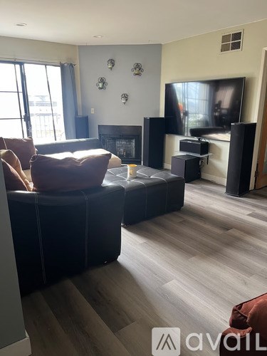 A living room with a brown couch and a television.