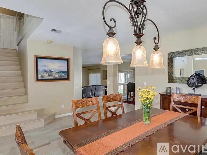 A dining room with a wooden table and chairs.