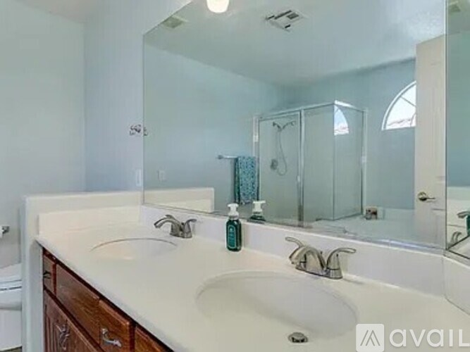 A bathroom with a white countertop and a large mirror.