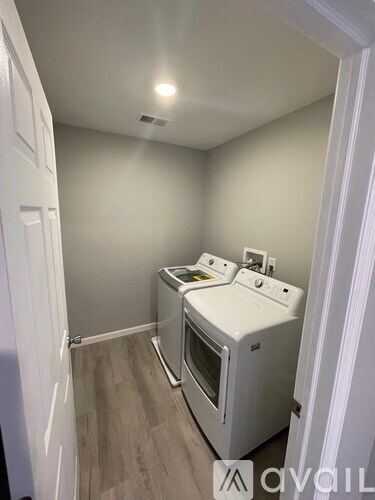 A small kitchen with a white oven and microwave.
