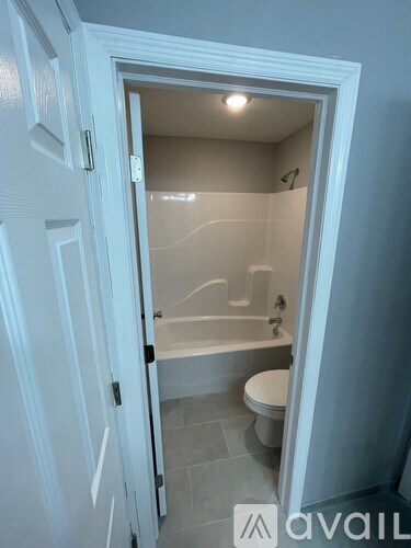 A bathroom with a toilet, tub, and sink.