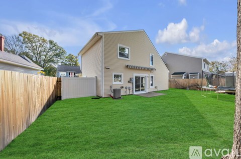 A house with a green lawn in front of it.