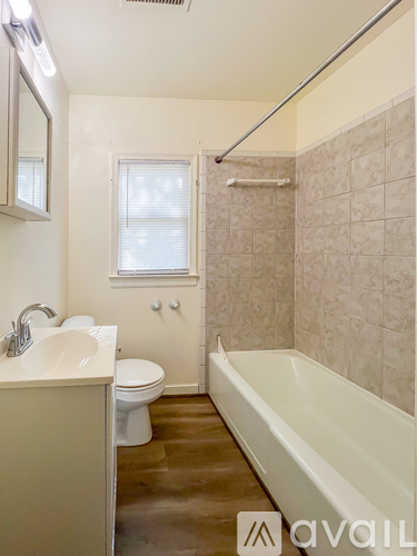A bathroom with a toilet, sink, and bathtub.